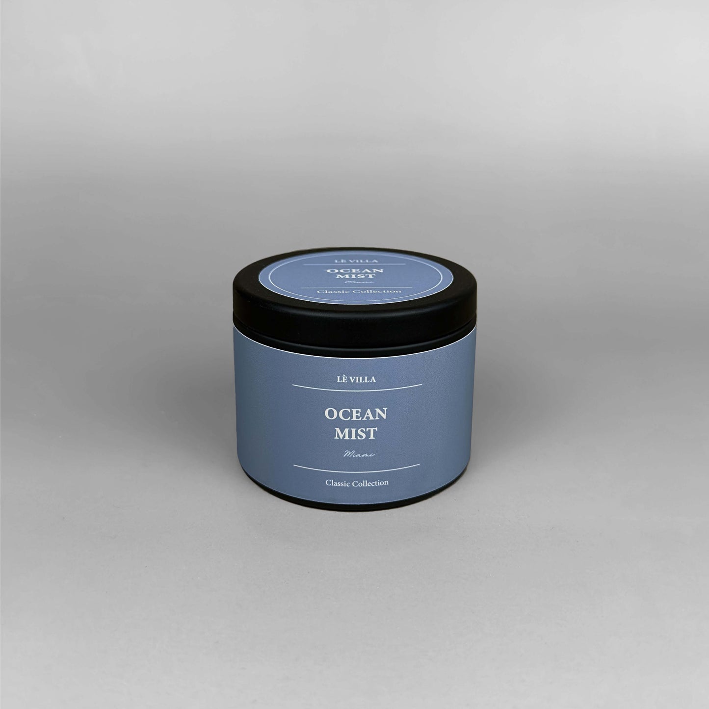 4oz Ocean Mist candle with matching label and glass design, styled as part of a serene coastal-inspired set.